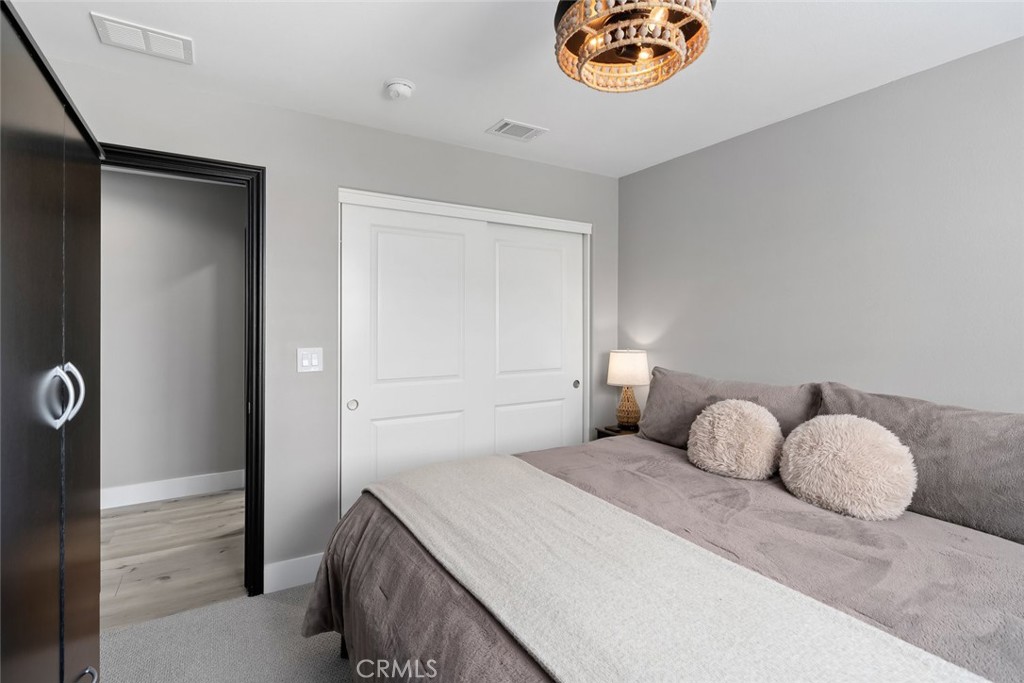 1177 Spring Azure Way, Unit 55 Nipomo, CA 93444 - Photo 36 of 75 a bedroom with a bed and a cabinets