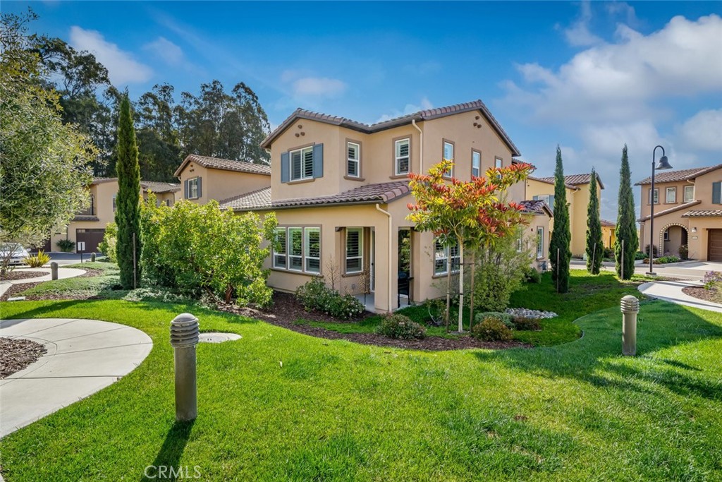 1177 Spring Azure Way, Unit 55 Nipomo, CA 93444 - Photo 61 of 75 a view of a house with a big yard plants and large trees