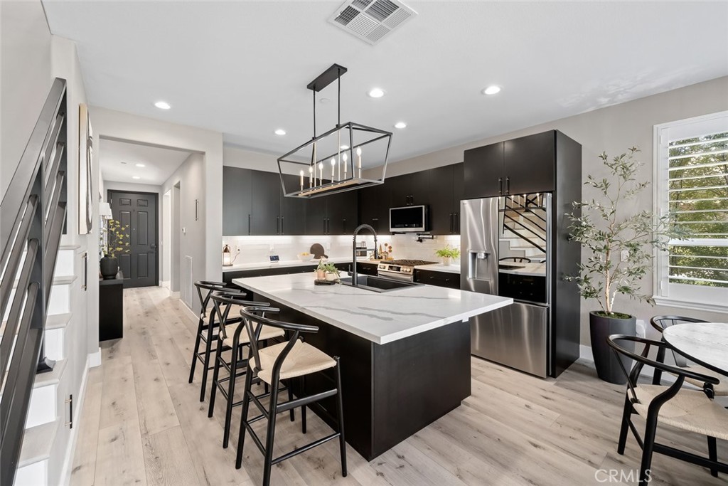 1177 Spring Azure Way, Unit 55 Nipomo, CA 93444 - Photo 9 of 75 a large kitchen with a table and chairs