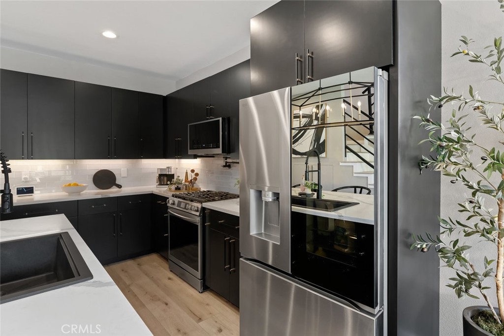 1177 Spring Azure Way, Unit 55 Nipomo, CA 93444 - Photo 10 of 75 a kitchen with stainless steel appliances kitchen island granite countertop a refrigerator and a stove top oven