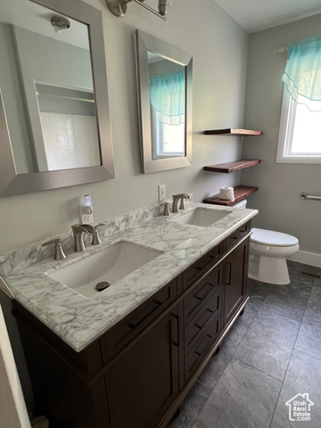 108 South Road Montpelier, ID 83254 - Photo 18 of 36 Full bath with double vanity and dark tile patterned floors