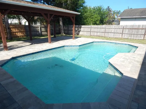swimming pool view with a seating space