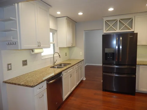 a kitchen with a refrigerator and a sink