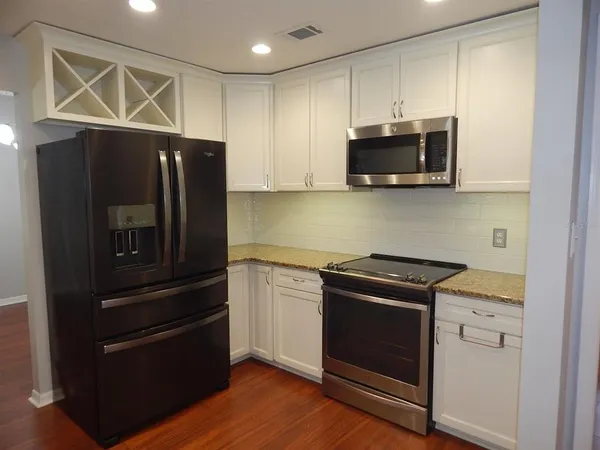 a kitchen with a refrigerator stove and microwave