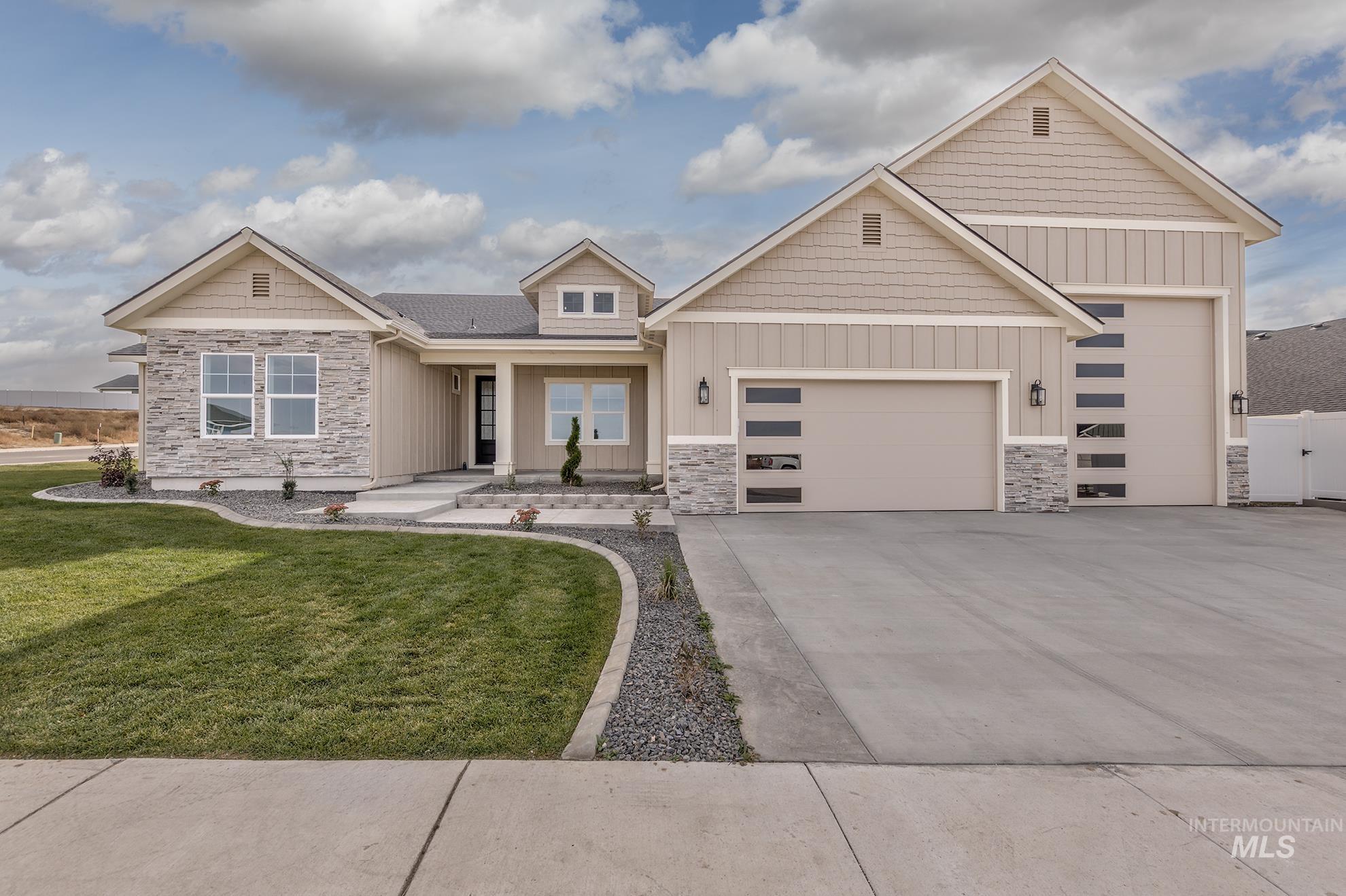 Craftsman inspired home featuring stone siding, board and batten siding, driveway, and a porch