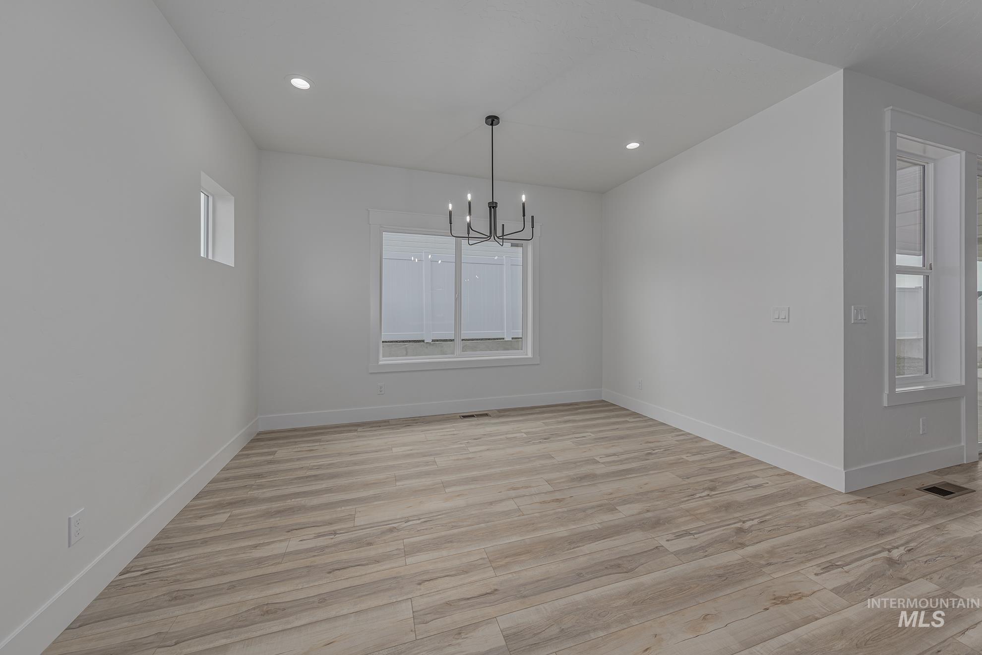 2810 Cypress Point Payette, ID 83661 - Photo 10 of 46 Unfurnished dining area featuring light wood finished floors, recessed lighting, and a chandelier