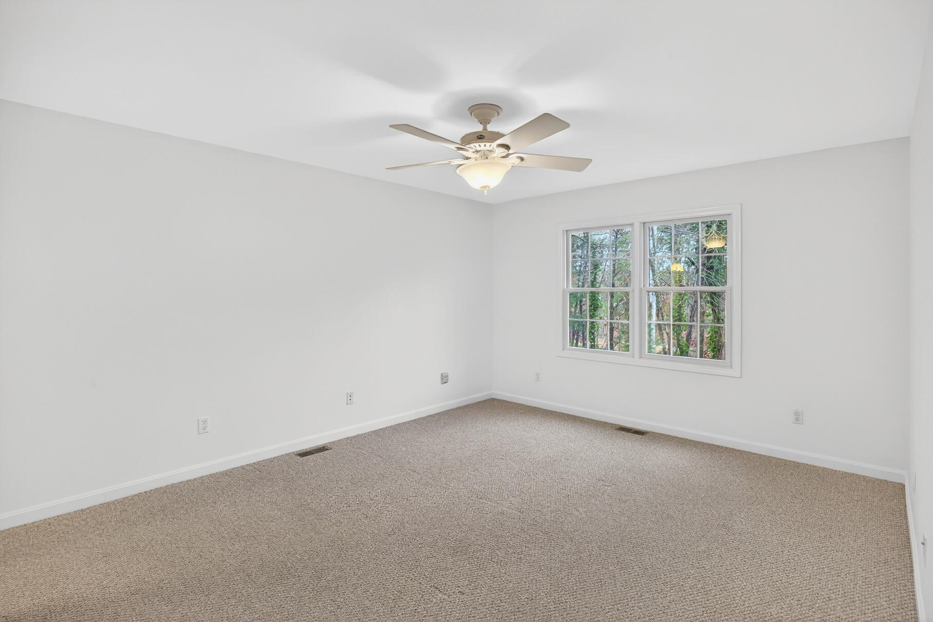 16 Gold Leaf Lane, Unit 16 Mashpee, MA 02649 - Photo 17 of 51 an empty room with a window and a ceiling fan