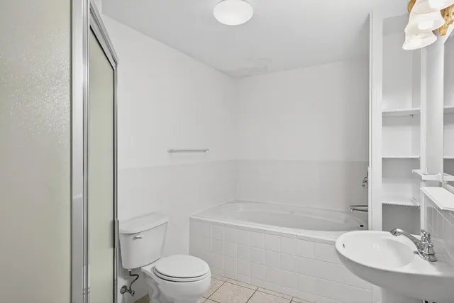 a bathroom with a toilet a sink and bathtub