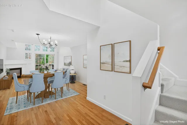 a kitchen with stainless steel appliances granite countertop a stove top oven a refrigerator a sink and dishwasher with wooden floor