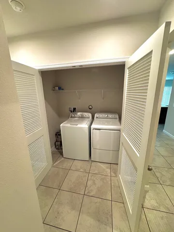 a view of a kitchen with microwave and cabinets