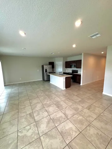 a kitchen with stainless steel appliances a refrigerator sink and stove