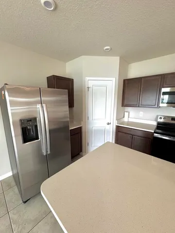 a kitchen with granite countertop a stove and a microwave