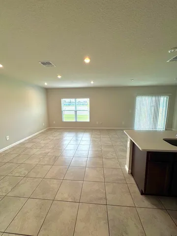 a view of an empty room and a window