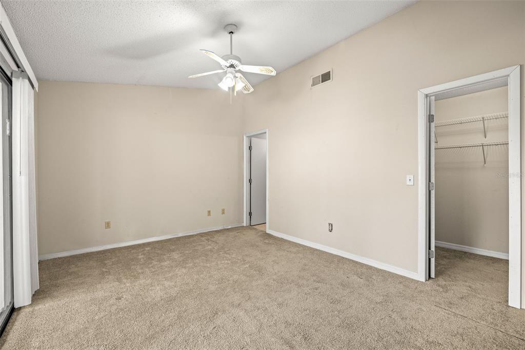 5100 Burchette Road, Unit 300 Tampa, FL 33647 - Photo 13 of 27 an empty room with a chandelier fan and closet area