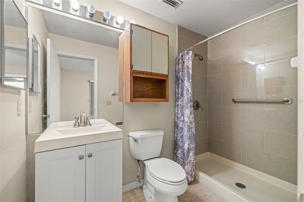 5100 Burchette Road, Unit 300 Tampa, FL 33647 - Photo 15 of 27 a bathroom with a sink toilet and shower