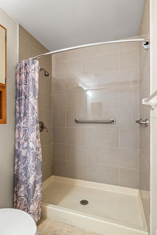 5100 Burchette Road, Unit 300 Tampa, FL 33647 - Photo 16 of 27 a bathroom with a bathtub and shower