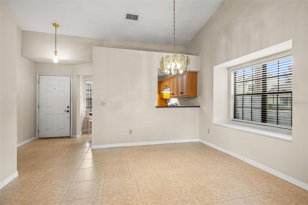 5100 Burchette Road, Unit 300 Tampa, FL 33647 - Photo 5 of 27 an empty room with chandelier fan and windows