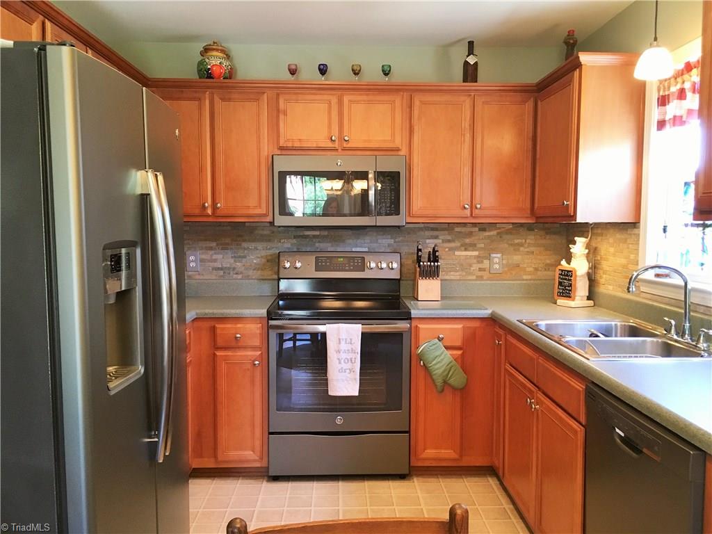 6028 Evans Mill Road High Point, NC 27265 - Photo 3 of 22 Nicely done kitchen with almost new charcoal appliances and lots of cabinets.