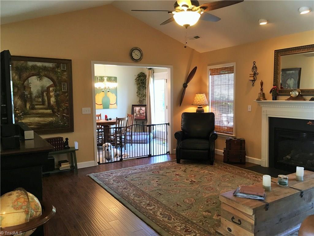 6028 Evans Mill Road High Point, NC 27265 - Photo 7 of 22 What a great space for entertaining! Lots of room in here to gather. Vaulted ceilings, nice floors, gas fireplace.