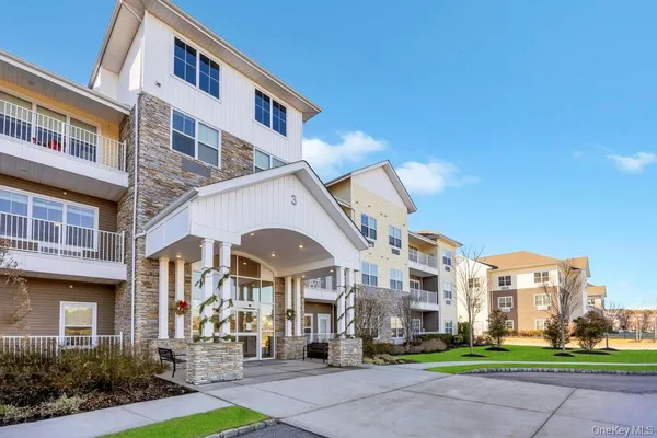 a front view of a building with a garden