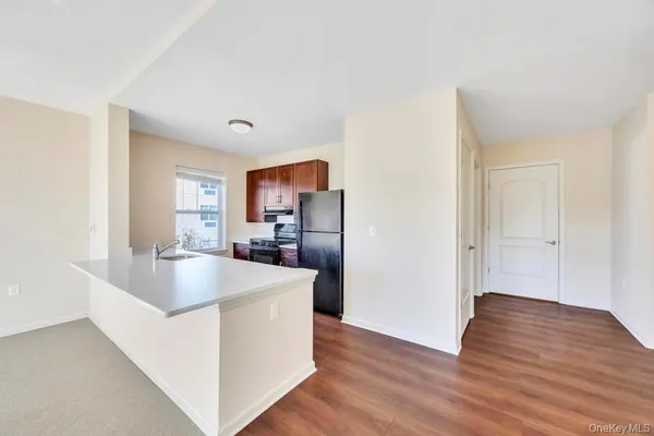 a kitchen with kitchen island a sink and a refrigerator
