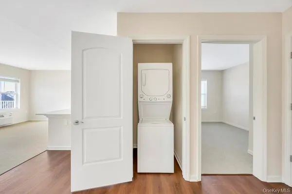 an empty room and wooden floor with a bathroom
