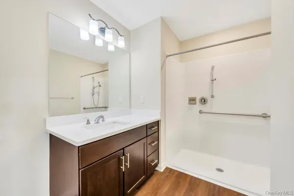 a bathroom with a sink mirror vanity and bathtub