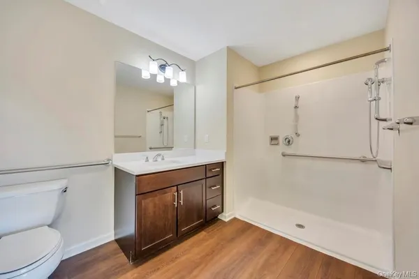 a bathroom with a sink a toilet and shower