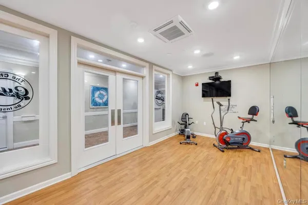 a room with gym equipment and a large window