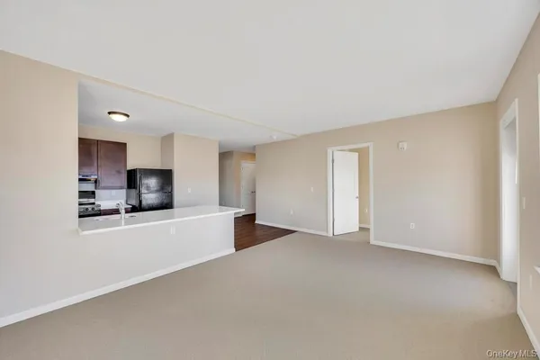 a view of a kitchen with a sink and a refrigerator