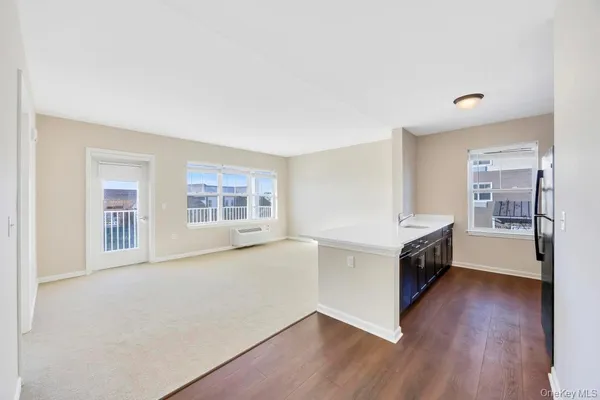 a view of a kitchen with a sink and wooden floor