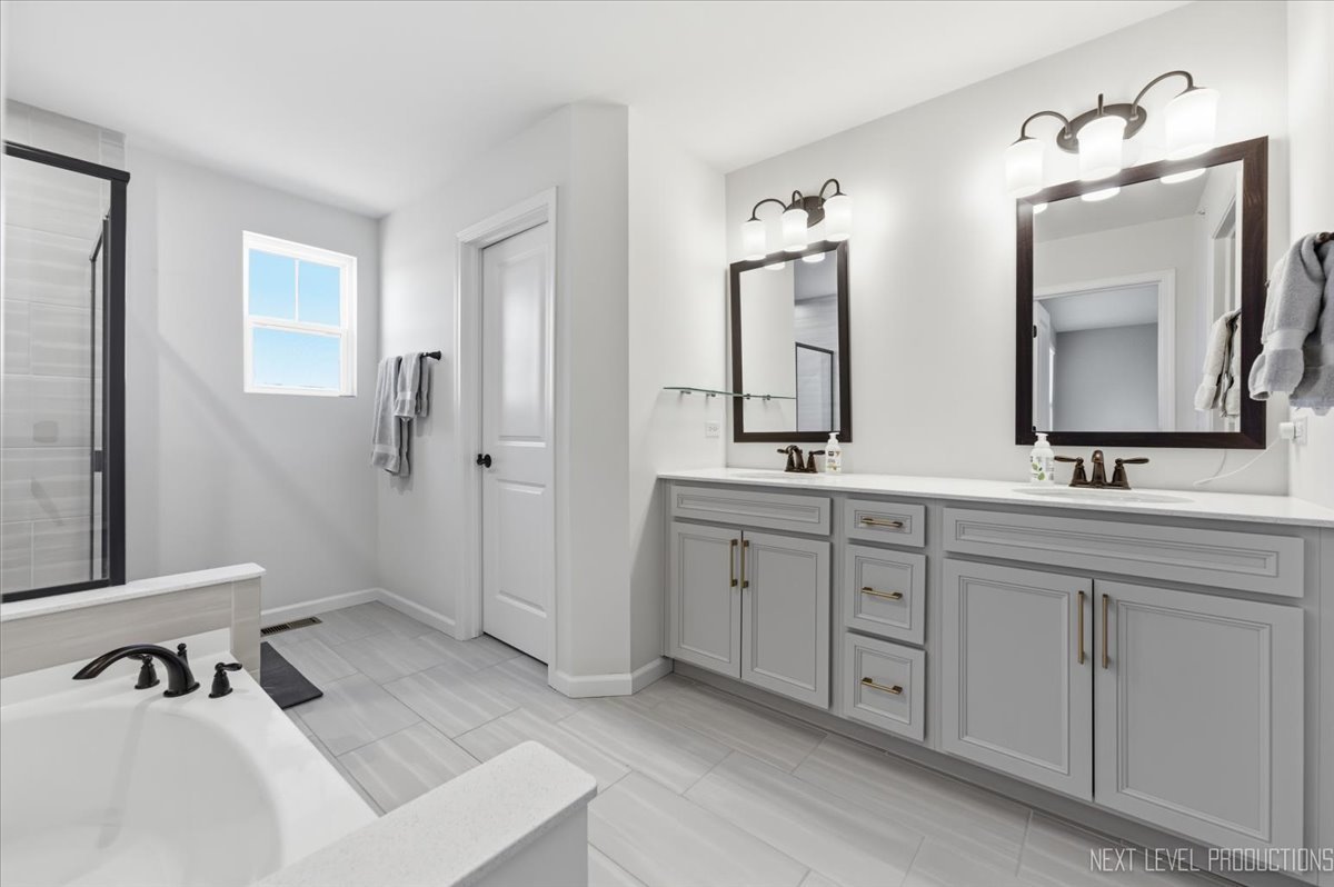2132 Weatherbee Lane Naperville, IL 60563 - Photo 11 of 23 a spacious bathroom with double sink and a mirror