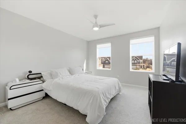 a bedroom with a bed flat screen tv and window