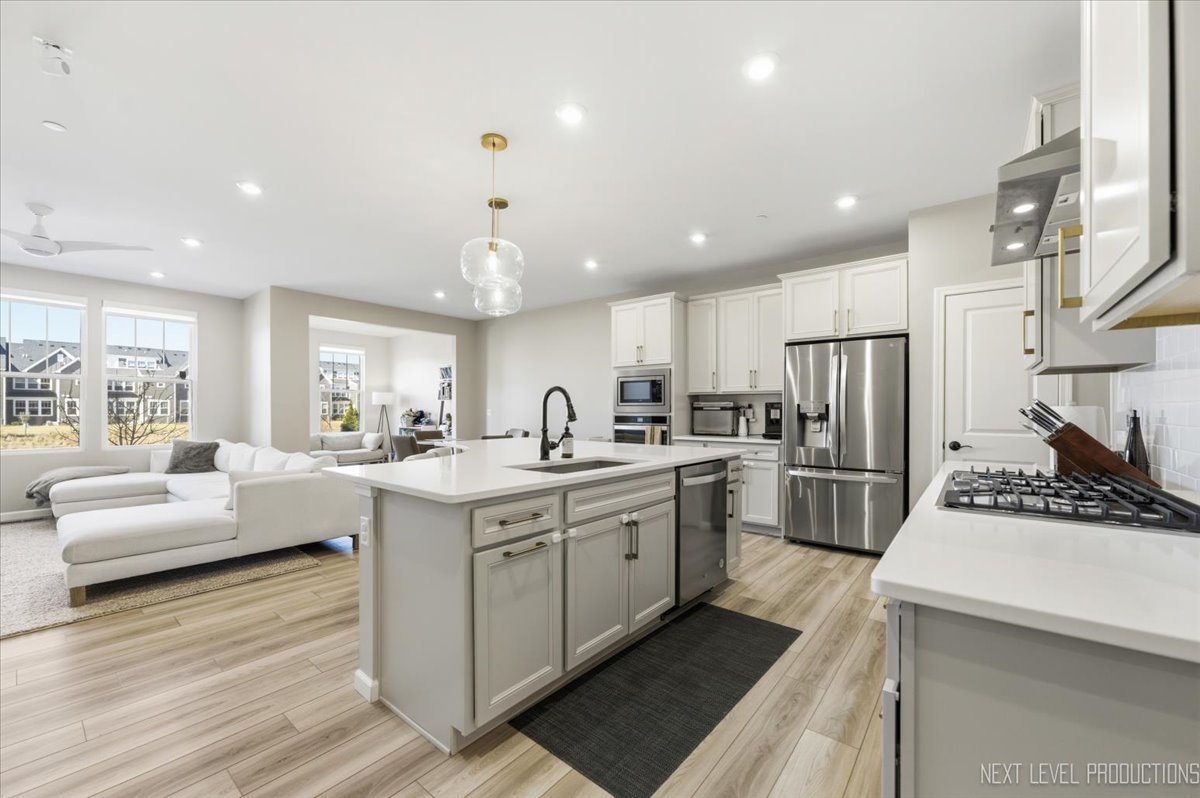 2132 Weatherbee Lane Naperville, IL 60563 - Photo 2 of 23 a kitchen with white cabinets and stainless steel appliances
