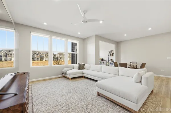 a living room with furniture and large windows