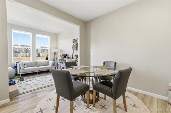 a view of a dining room with furniture and wooden floor
