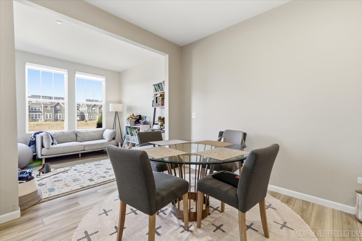 2132 Weatherbee Lane Naperville, IL 60563 - Photo 8 of 23 a view of a dining room with furniture and wooden floor