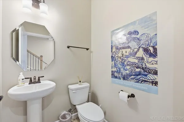 a bathroom with a toilet sink and mirror