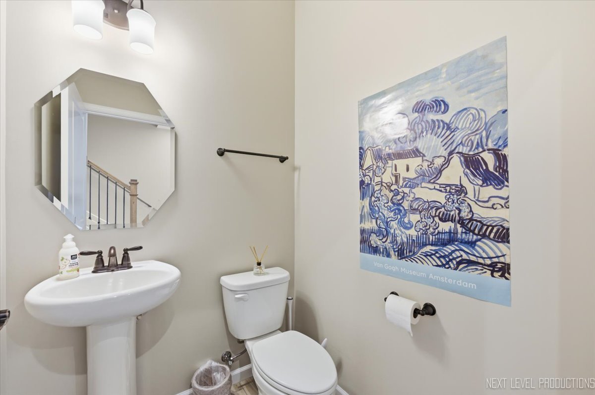 2132 Weatherbee Lane Naperville, IL 60563 - Photo 9 of 23 a bathroom with a toilet sink and mirror