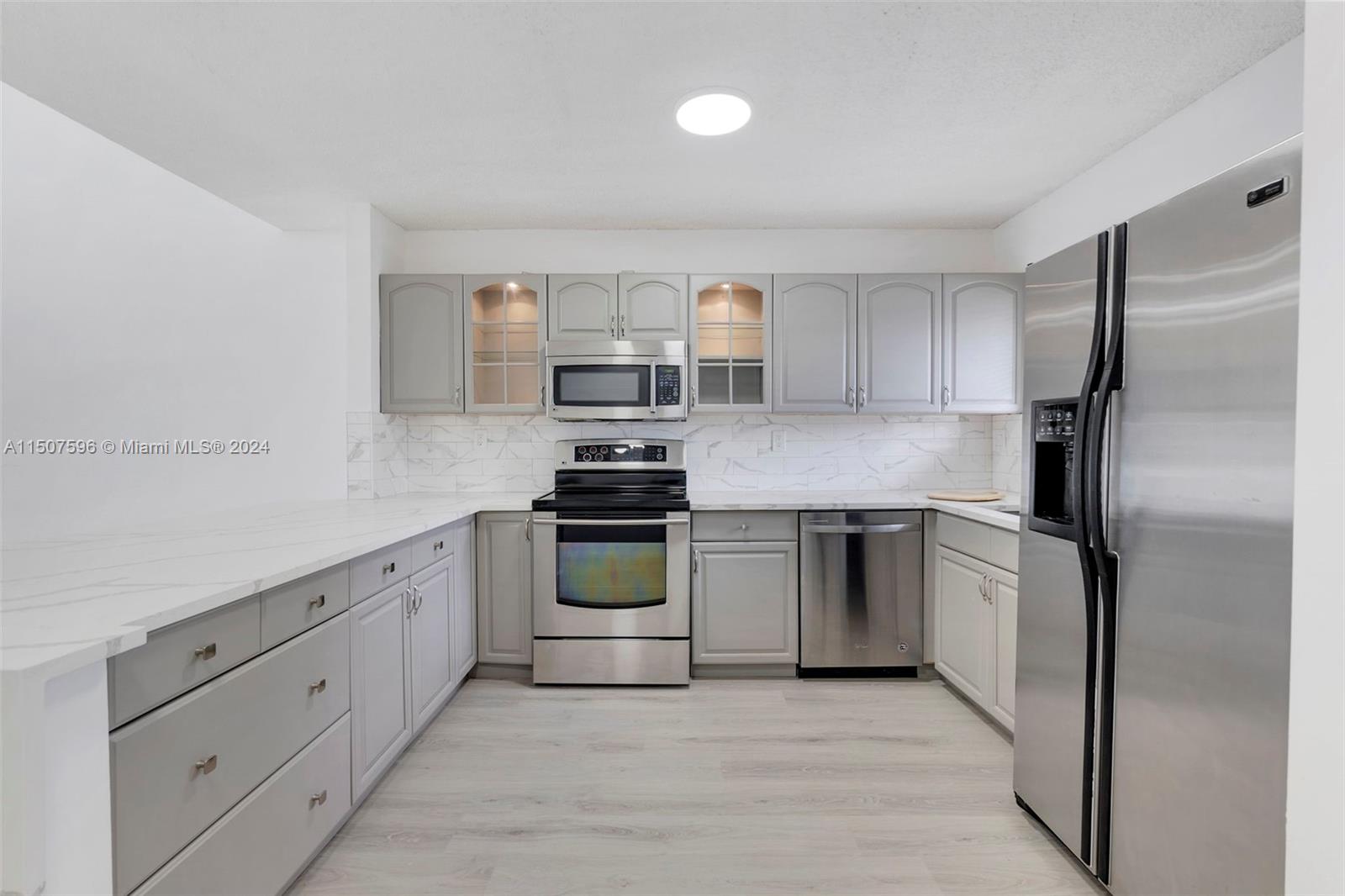645 Banks Road Margate, FL 33063 - Photo 13 of 38 a kitchen with cabinets stainless steel appliances and a window