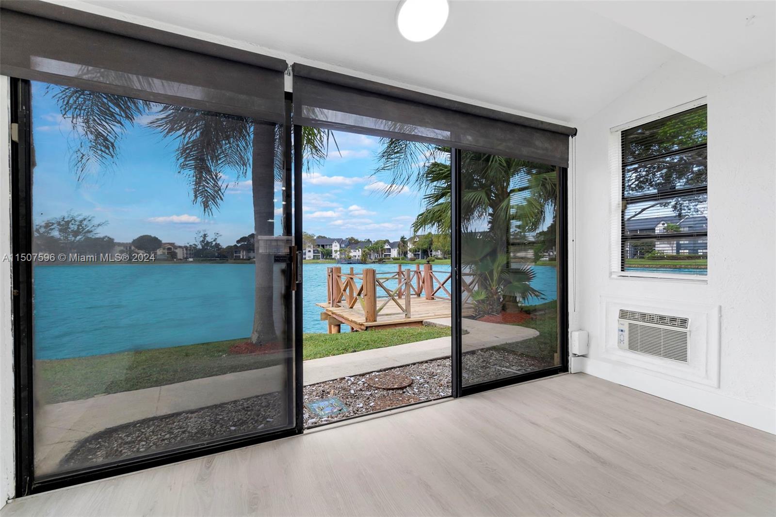 645 Banks Road Margate, FL 33063 - Photo 14 of 38 a view of a living room and a floor to ceiling window