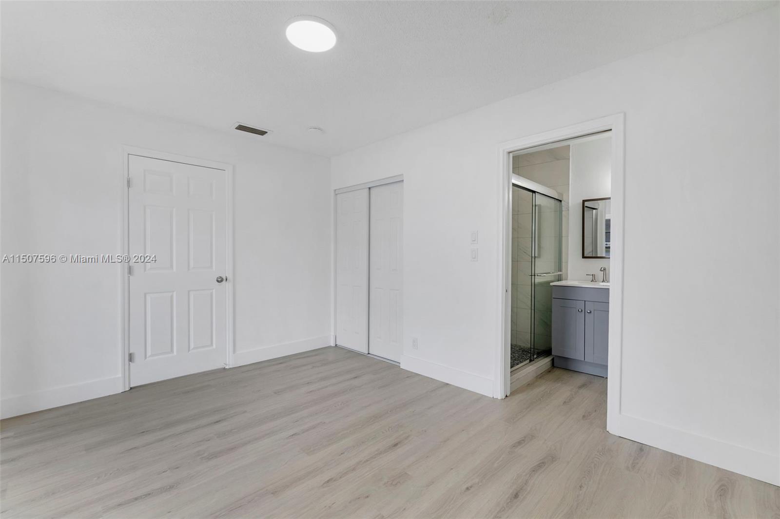 645 Banks Road Margate, FL 33063 - Photo 20 of 38 a view of empty room with wooden floor and closet