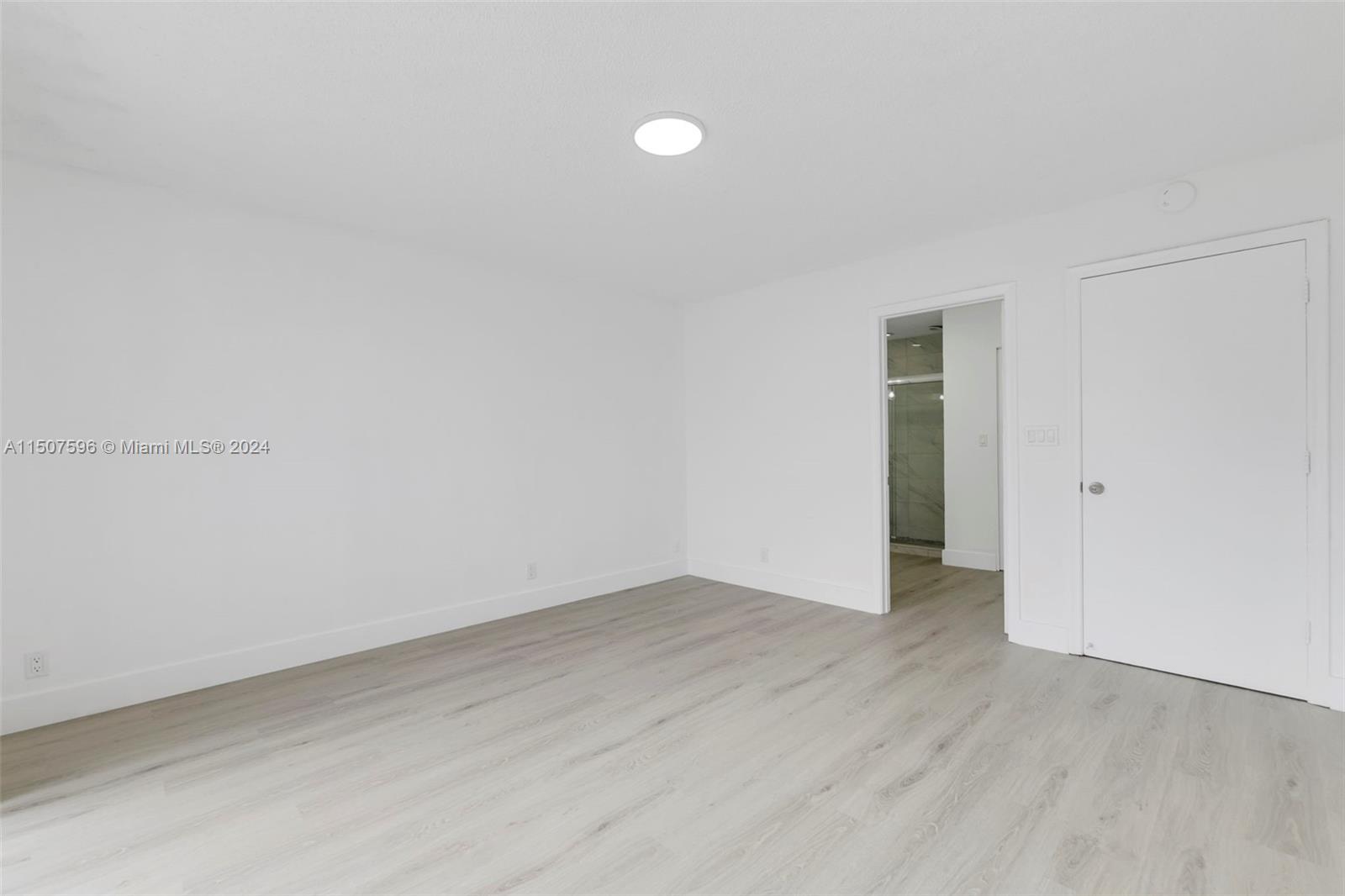 645 Banks Road Margate, FL 33063 - Photo 23 of 38 a view of an empty room with wooden floor