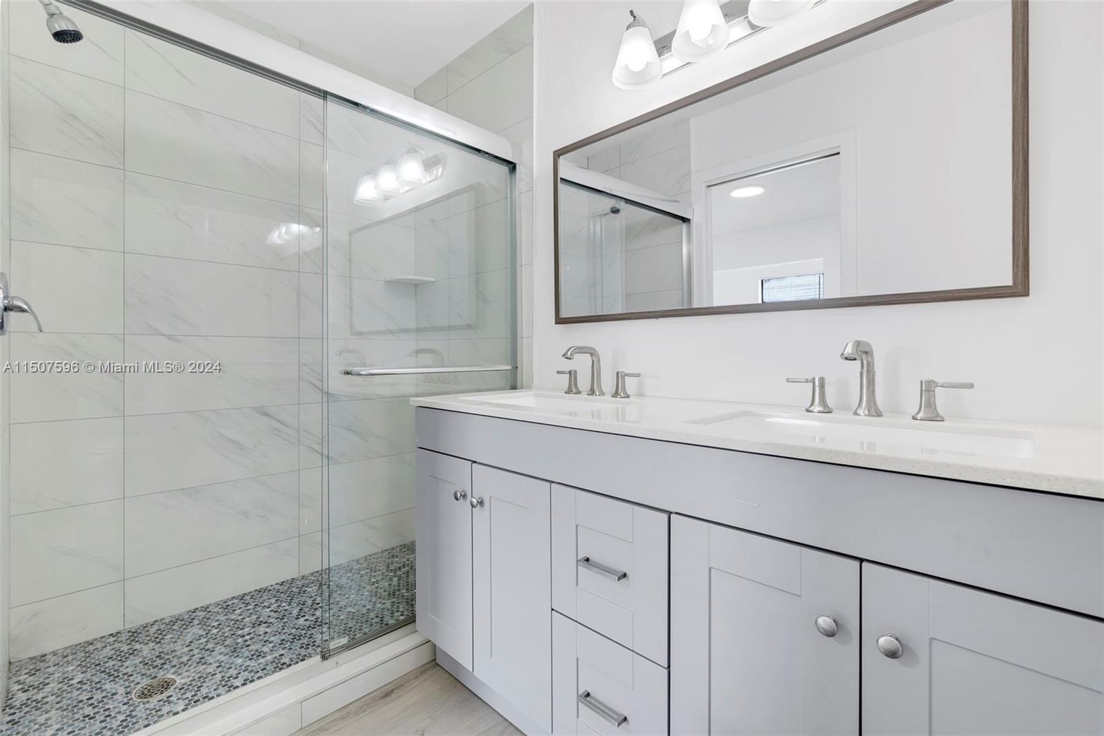 645 Banks Road Margate, FL 33063 - Photo 24 of 38 a bathroom with a shower sink and mirror