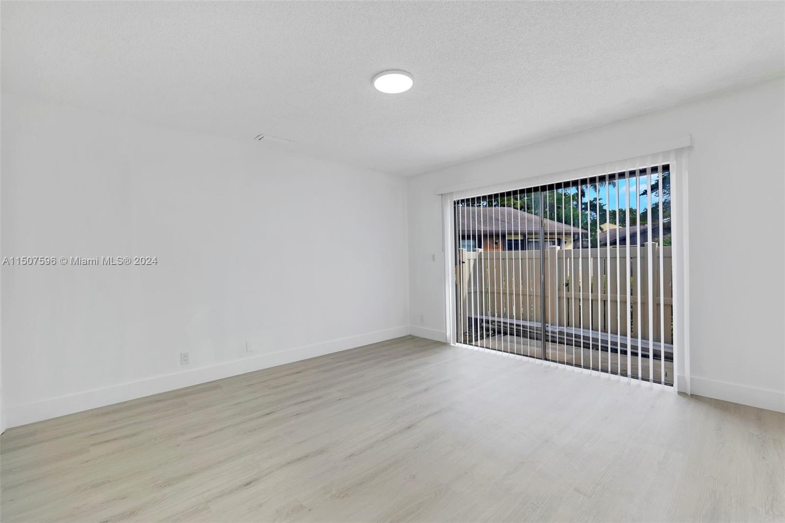 645 Banks Road Margate, FL 33063 - Photo 25 of 38 an empty room with wooden floor and windows