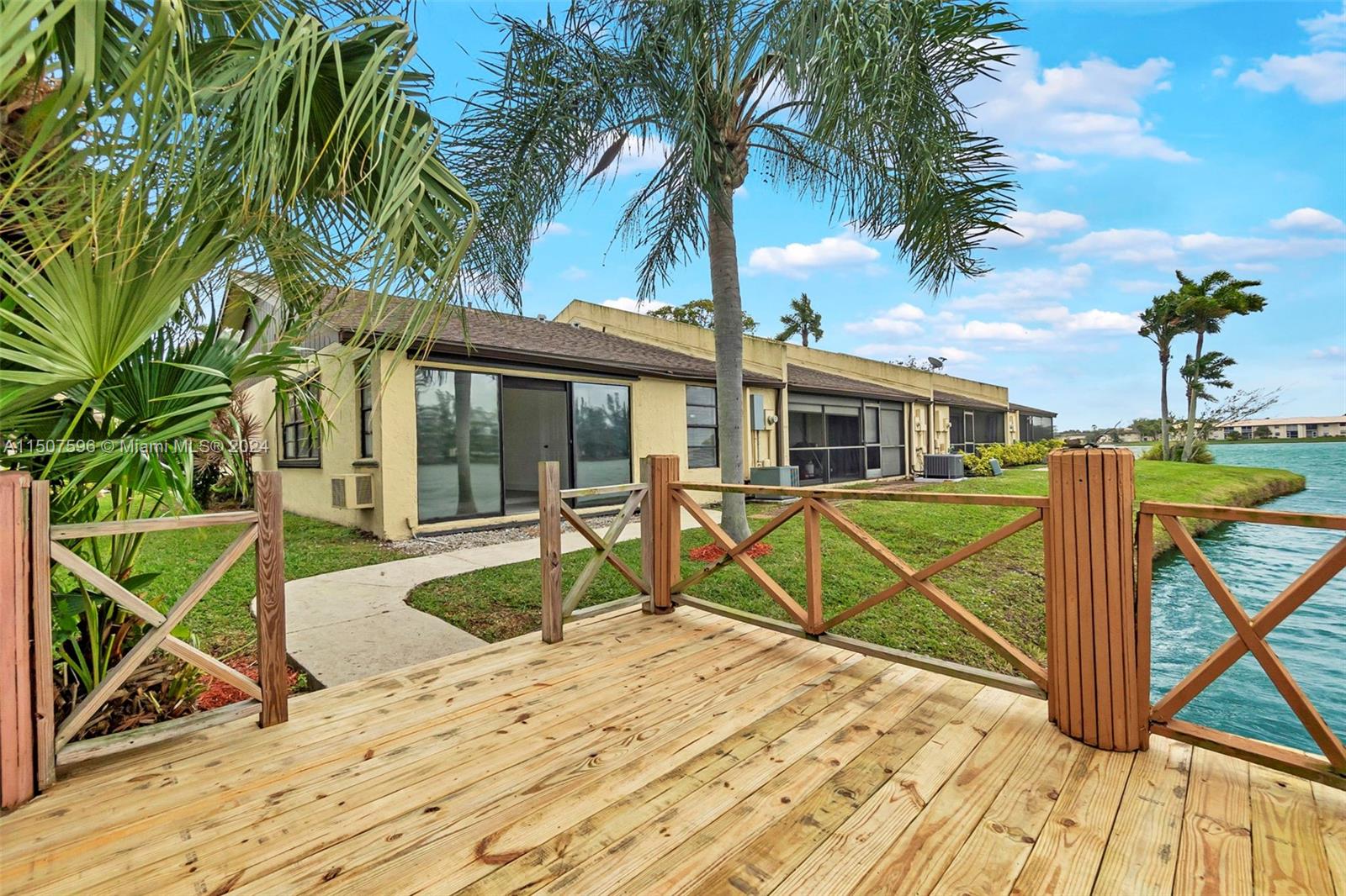 645 Banks Road Margate, FL 33063 - Photo 30 of 38 a view of a house with wooden deck and a palm tree