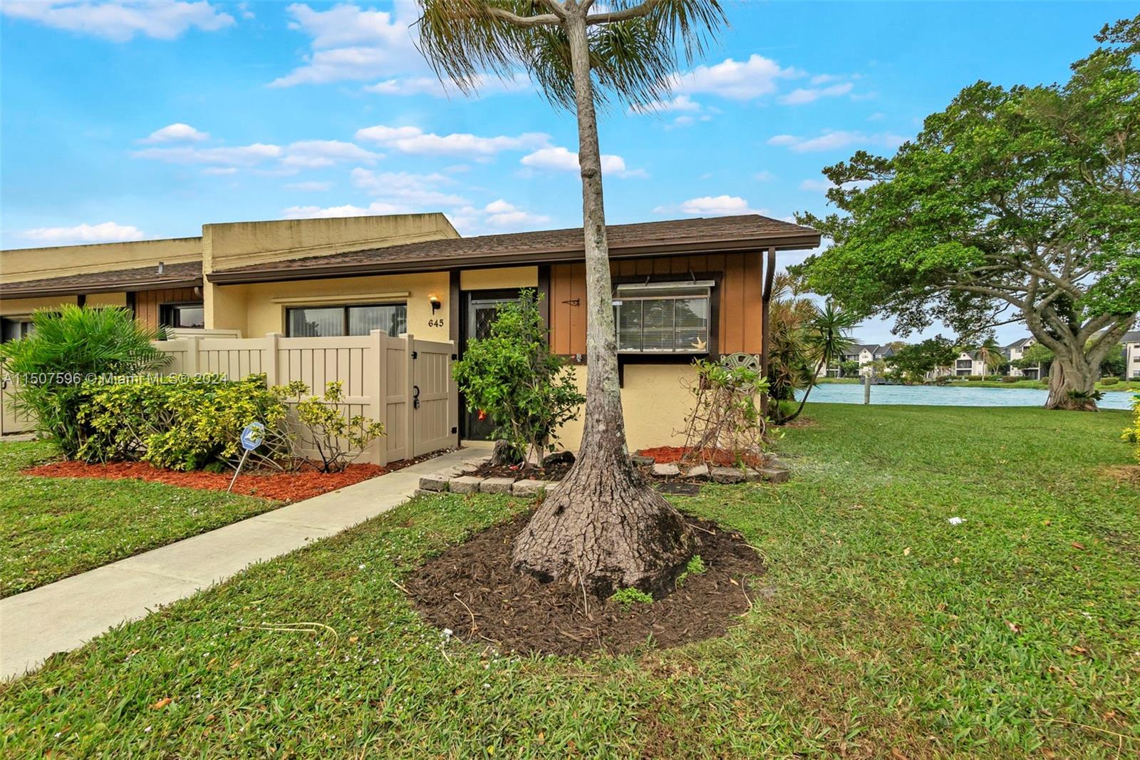 645 Banks Road Margate, FL 33063 - Photo 6 of 38 a front view of a house with garden