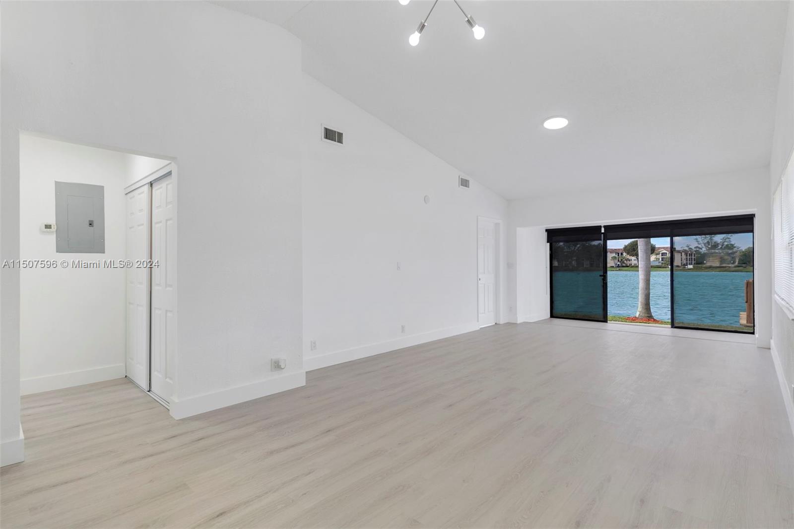 645 Banks Road Margate, FL 33063 - Photo 9 of 38 an empty room with wooden floor and windows