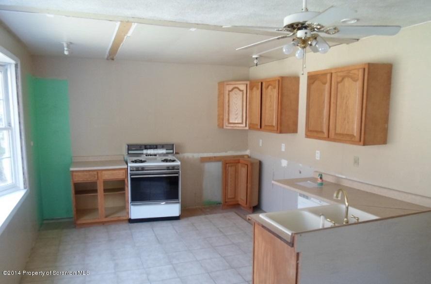 175 Tea Pond Nicholson, PA 18446 - Photo 4 of 14 a kitchen with stainless steel appliances granite countertop a sink and a stove