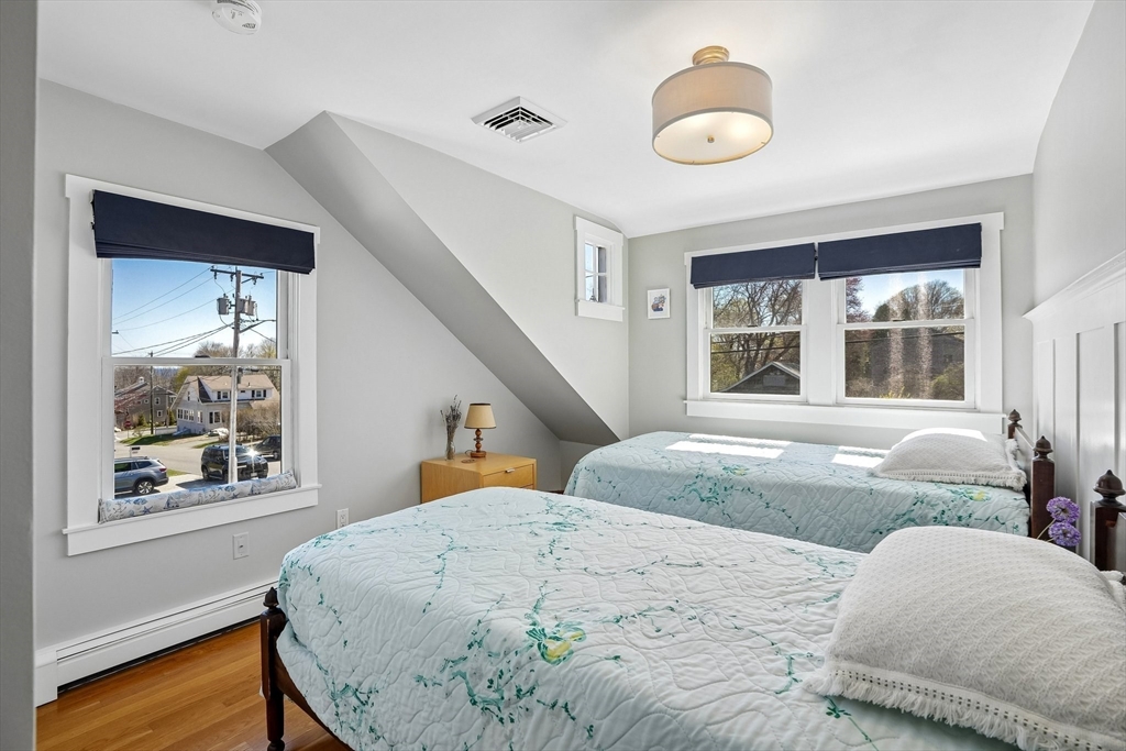 12 Hawley Road Scituate, MA 02066 - Photo 9 of 24 a bedroom with a bed and wooden floor